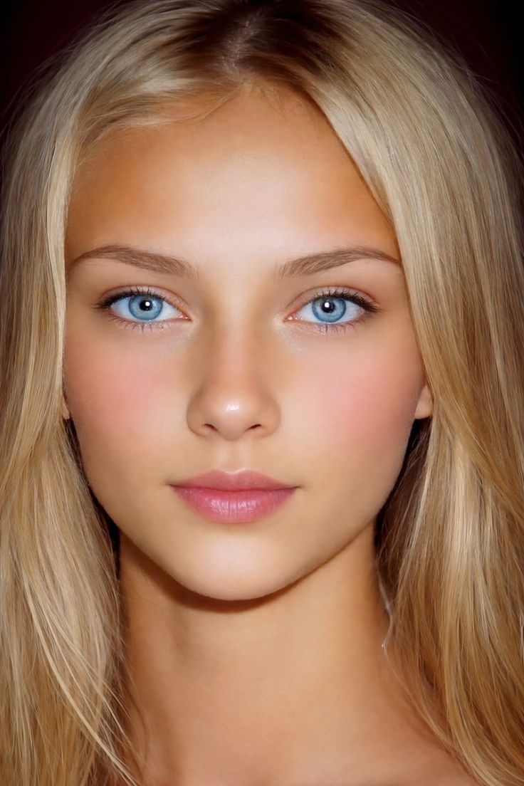 Close up portrait of a young person with blonde hair and blue eyes
