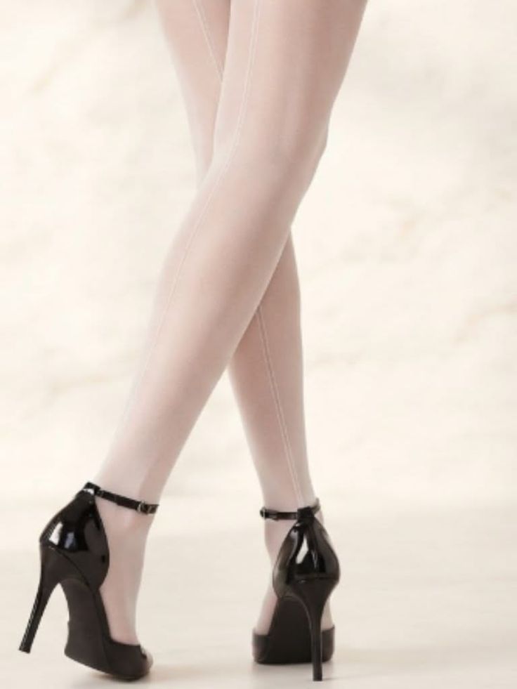 Woman's legs in white seamed stockings and black high heels
