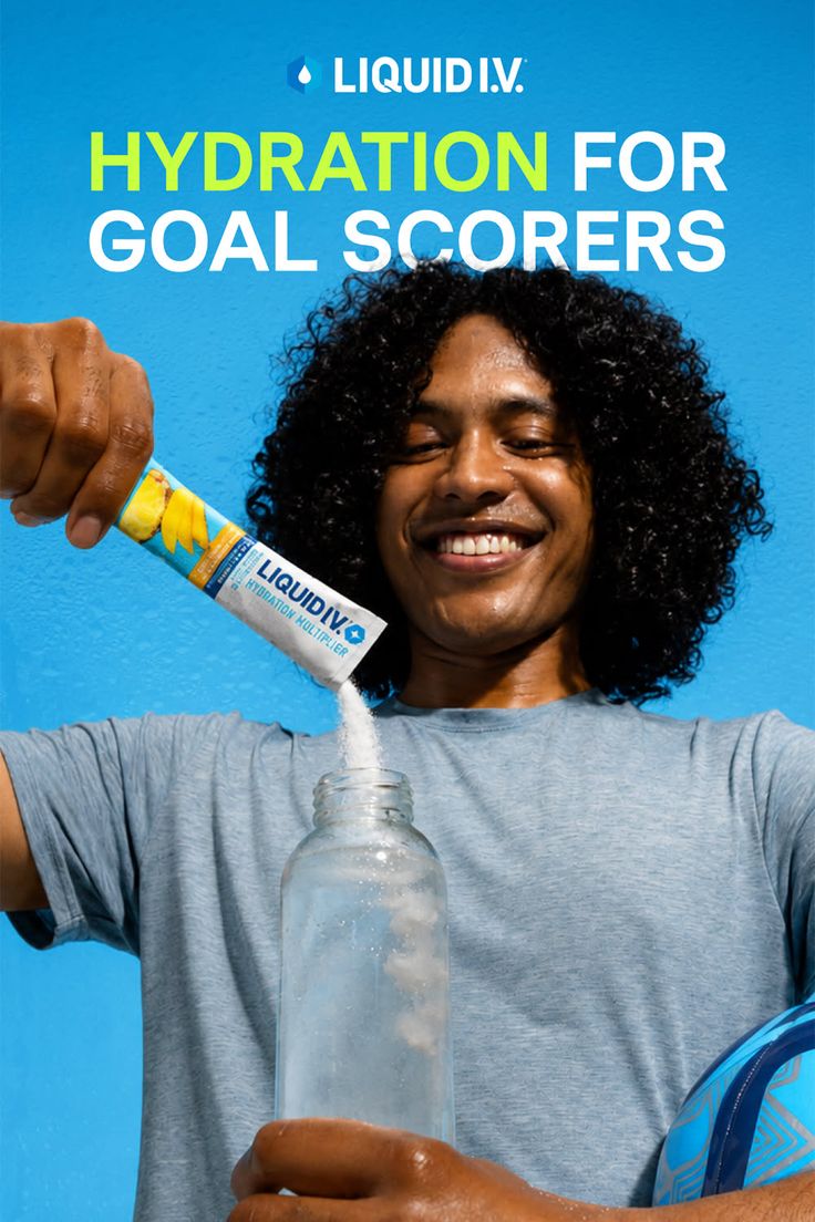 Man with curly hair pouring hydration powder into a water bottle