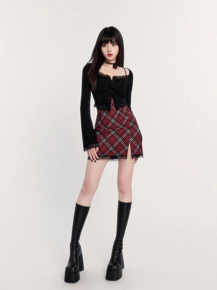 Woman with long black hair wearing a plaid skirt and black boots