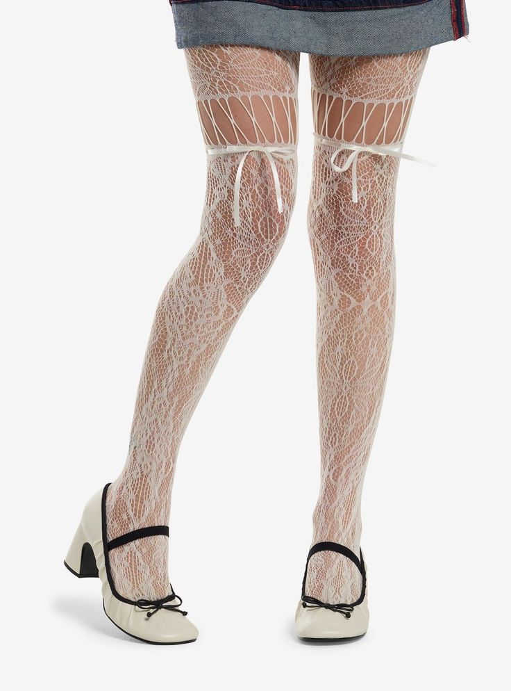 Person wearing white lace stockings with ribbons, a denim skirt, and Mary Jane shoes