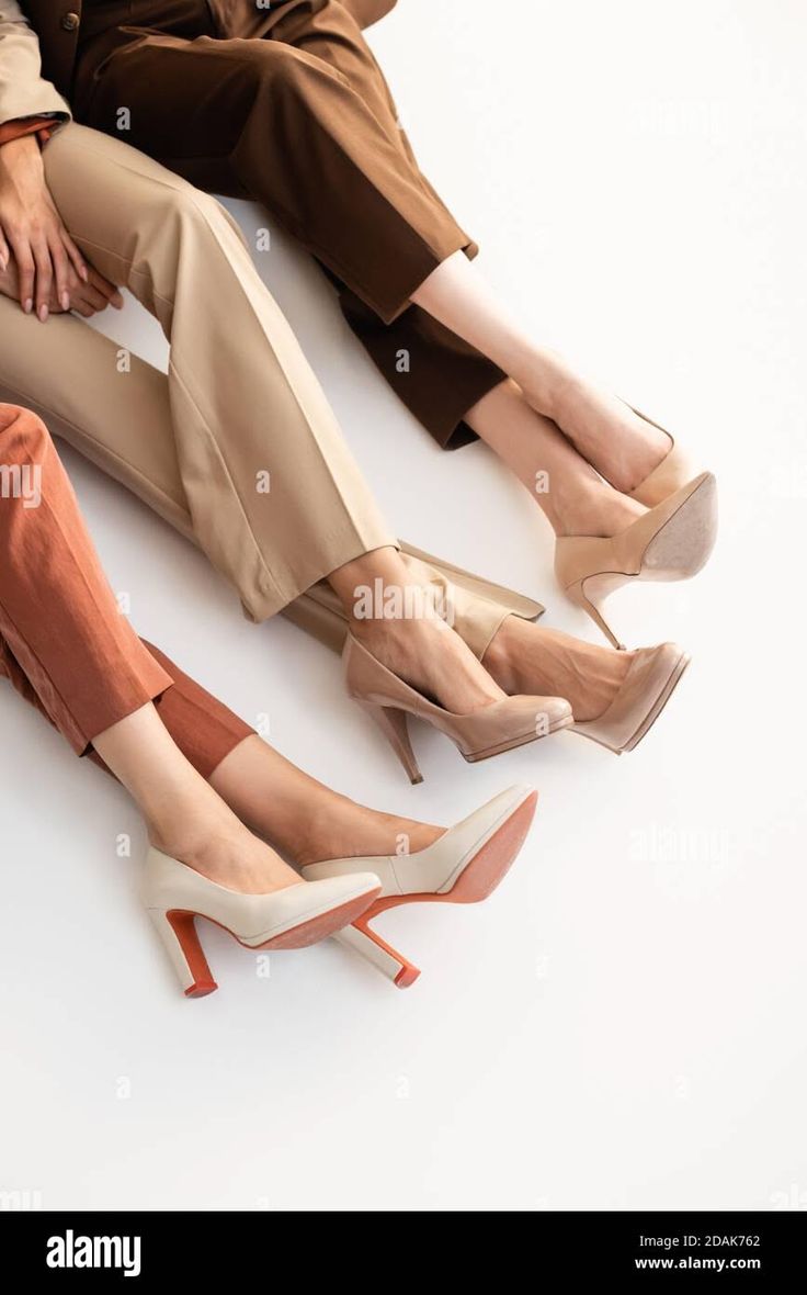Three people wearing business casual attire and high heels on a white background