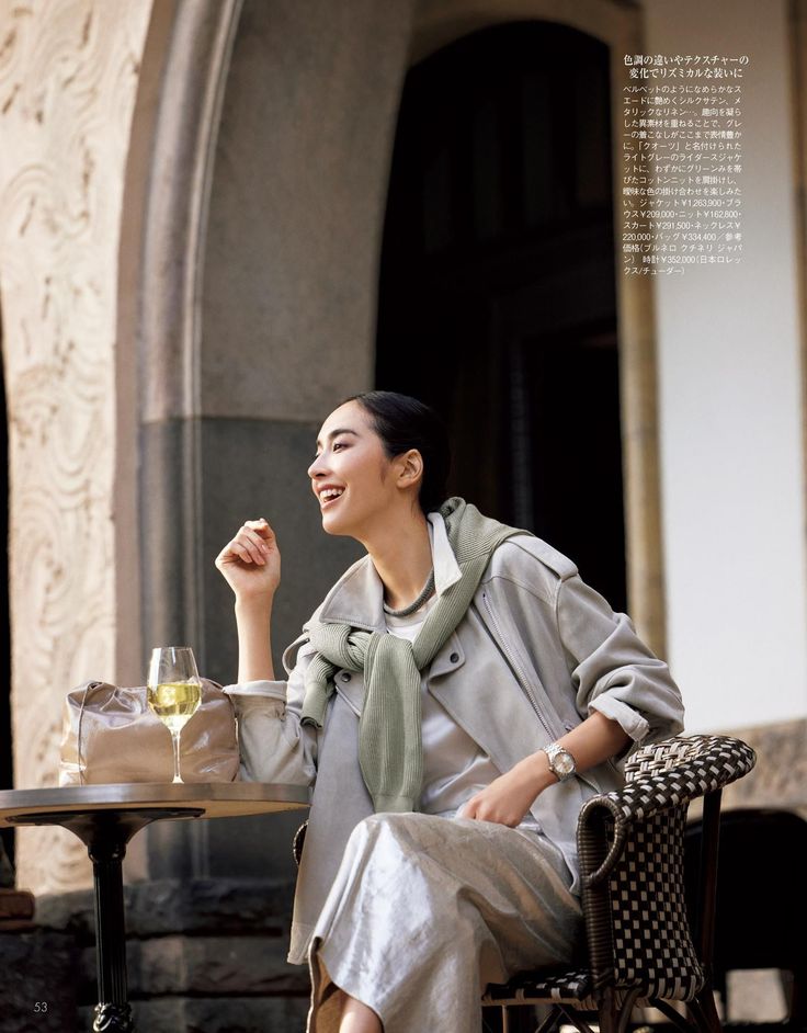 Woman with a happy expression sitting at an outdoor cafe table
