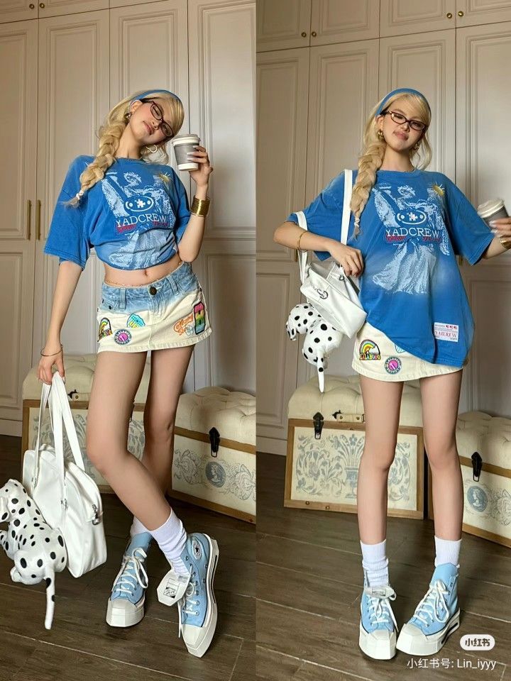 Woman with blonde braided hair in a blue t-shirt and denim skirt indoors