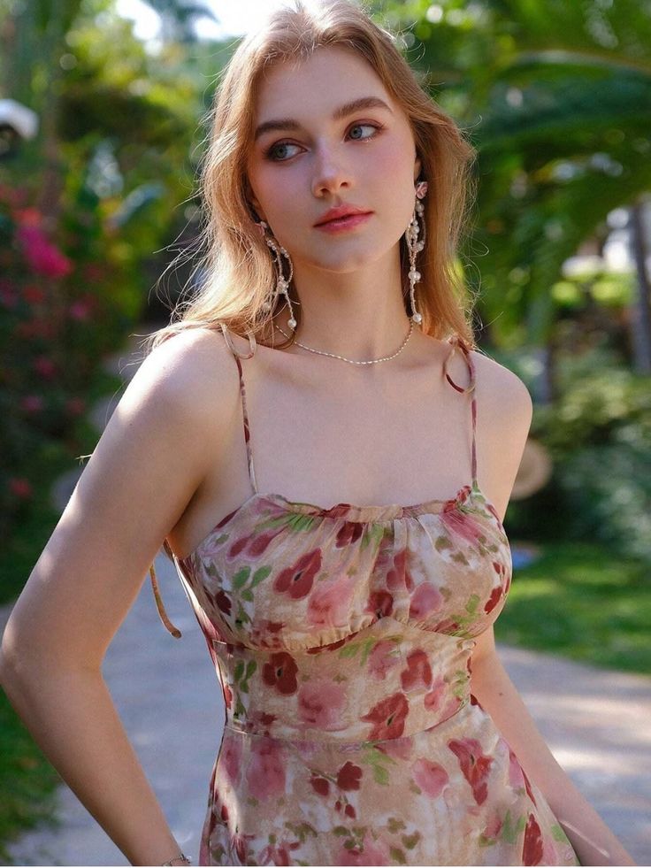 Woman in a floral dress with long blonde hair outdoors