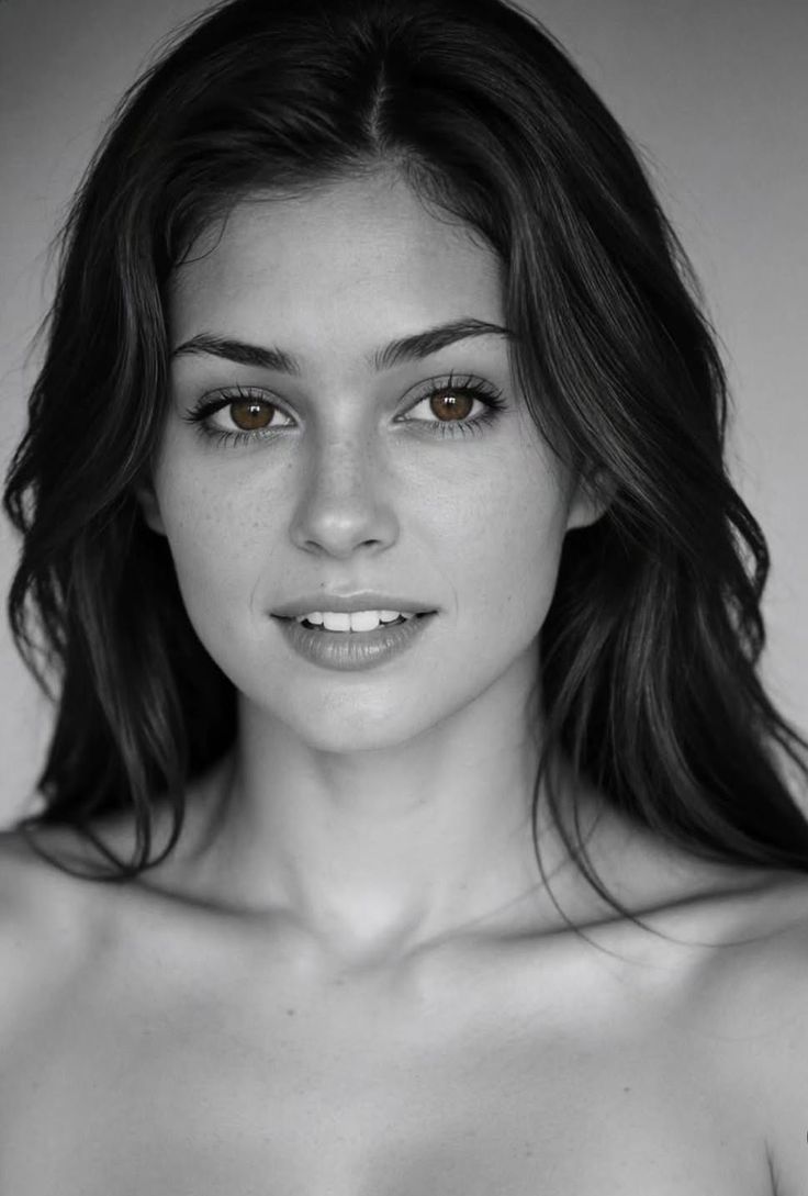 Woman with long dark hair and brown eyes in a black and white portrait