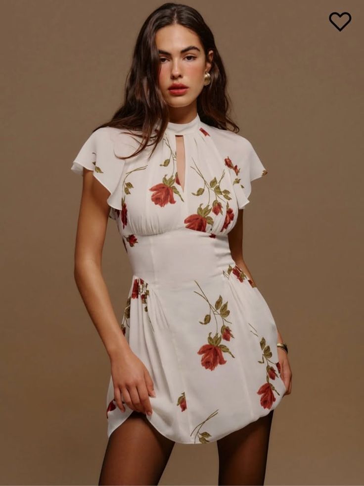 Woman in a white floral dress with a high neck and short sleeves