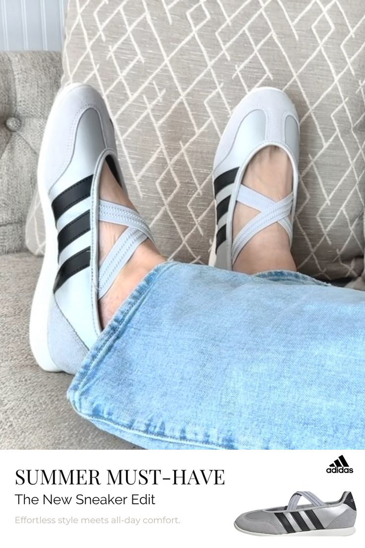 Person wearing light wash jeans and grey sneakers with black stripes on a patterned couch