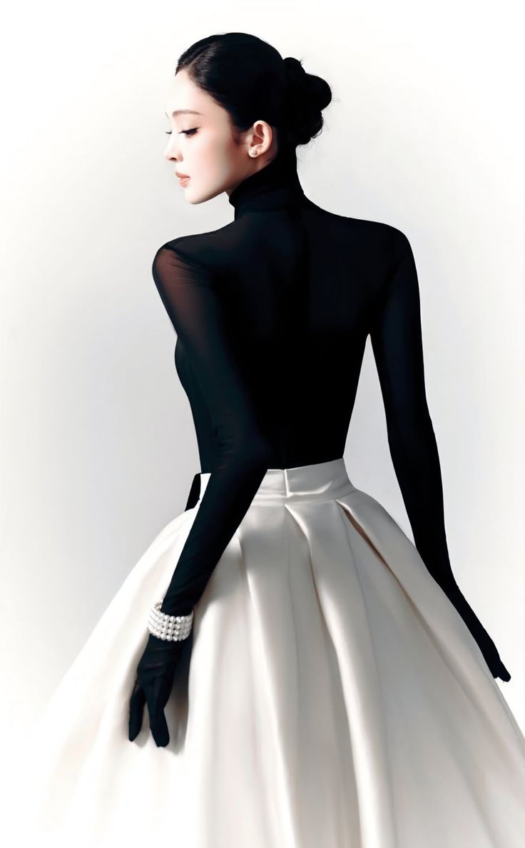 Woman in a black turtleneck and white skirt with a pearl bracelet and gloves