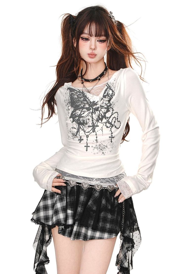 Woman with twin tails and dark makeup wearing a plaid skirt and gothic accessories