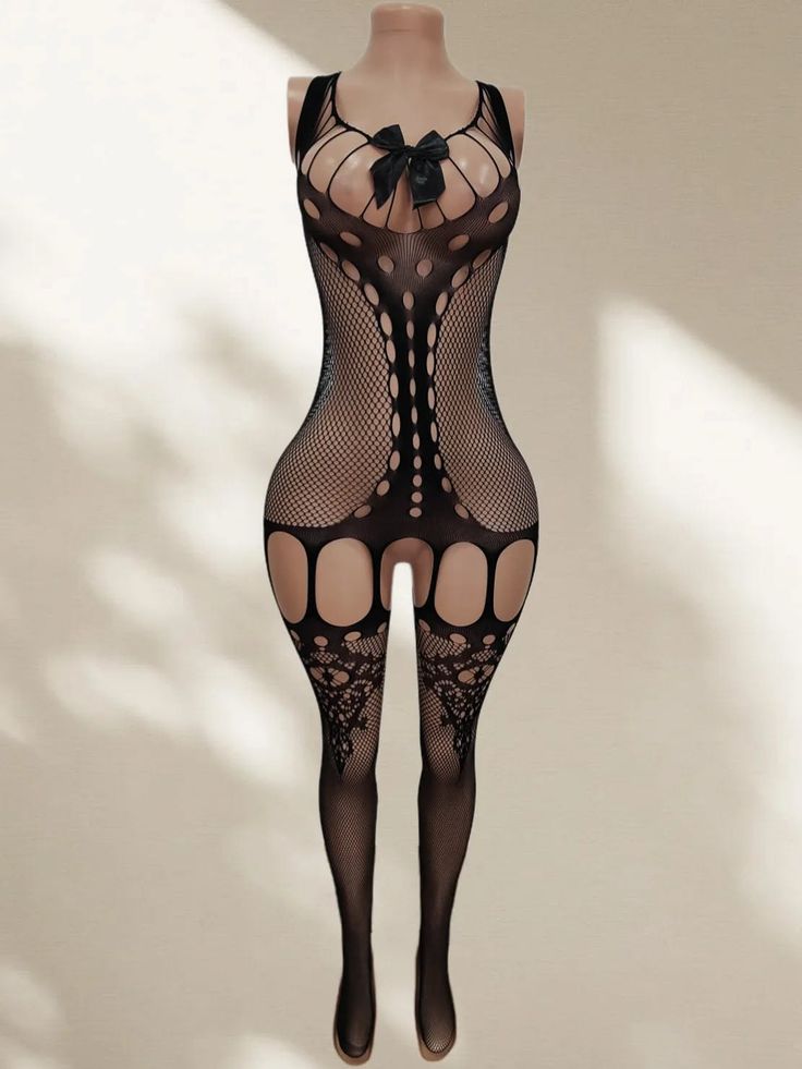 Black fishnet bodysuit with a bow and cut-out design on a mannequin