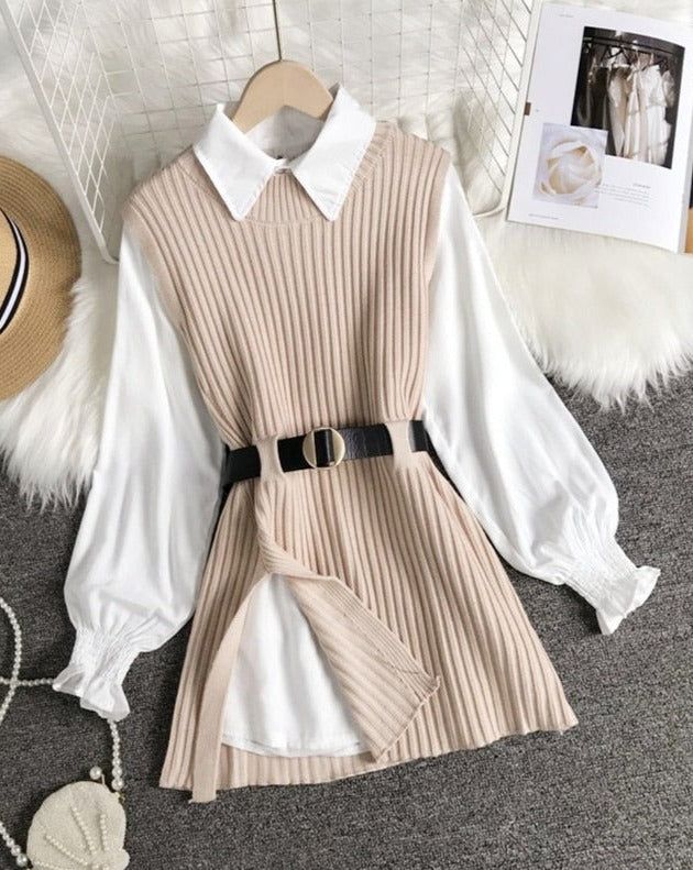 Knitted vest over a white collared shirt with a black belt