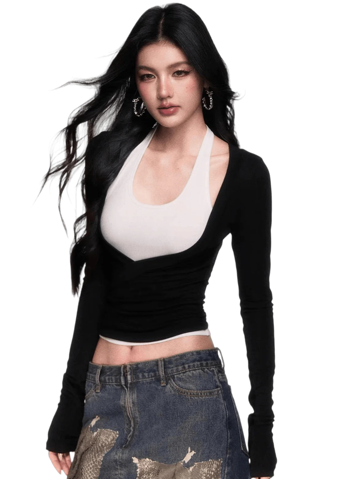Woman with long black hair wearing a cropped top and denim skirt