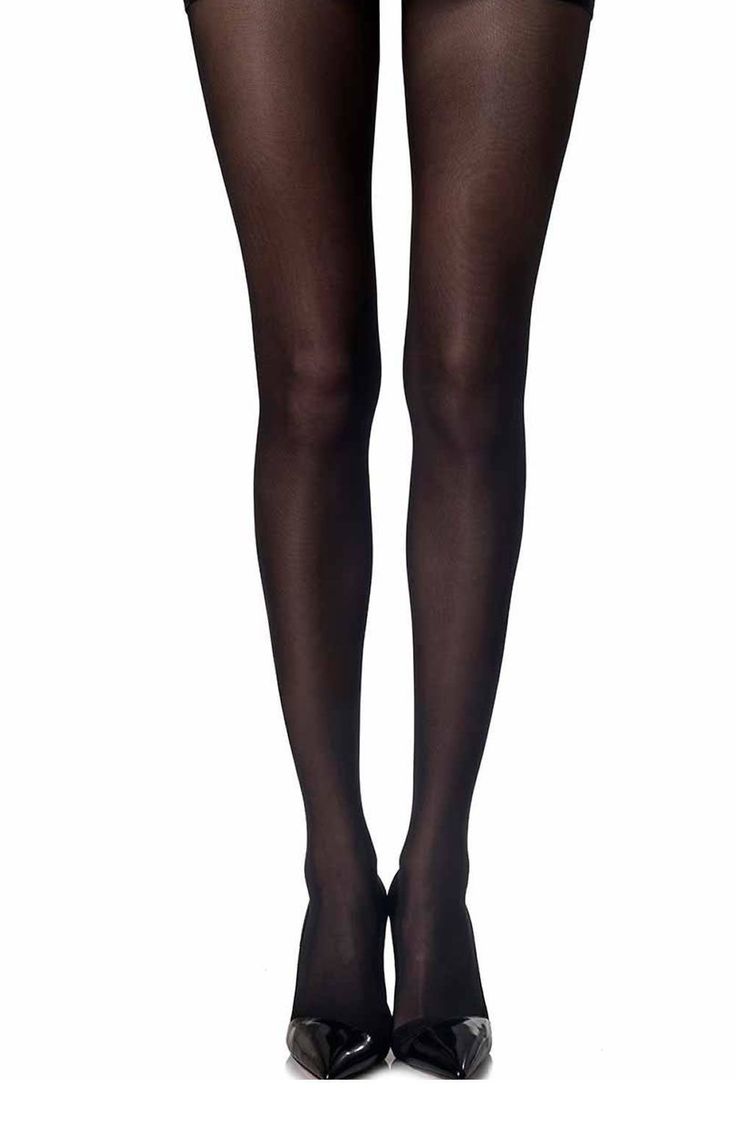 Person wearing black tights and high heels on a white background