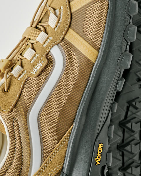 Close up of a brown hiking shoe with a textured fabric and rubber sole