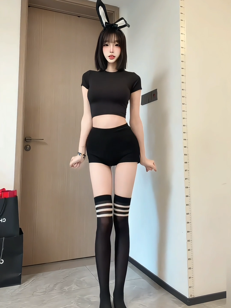 Anime style character in a black crop top, shorts, and bunny ears