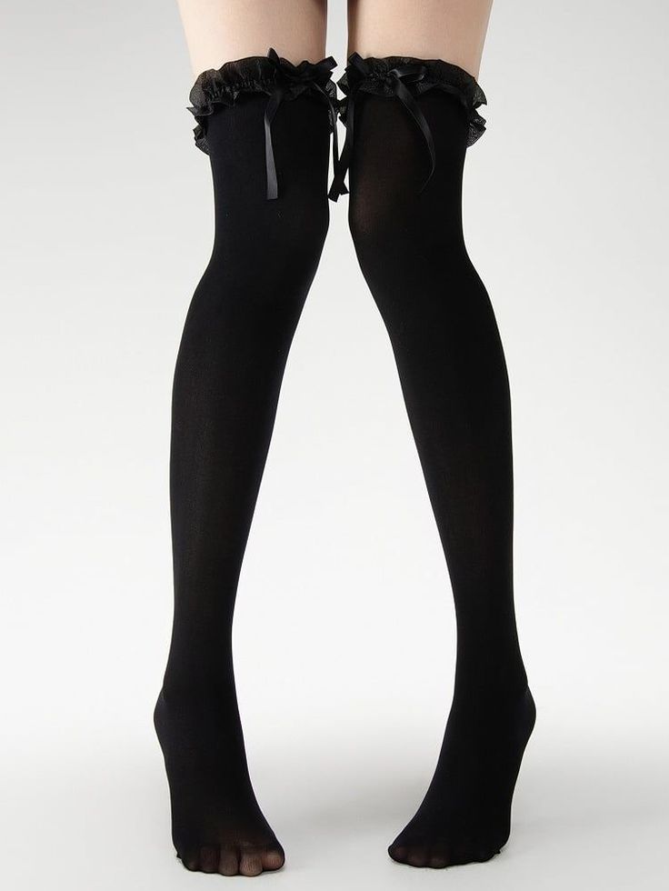 Legs wearing black thigh-high socks with ruffle trim and bows