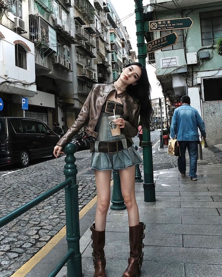 Woman in a leather jacket and mini skirt on a city street