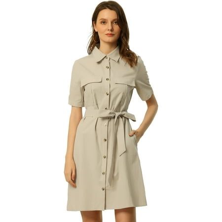 Woman in a light beige short-sleeve shirt dress with a belted waist