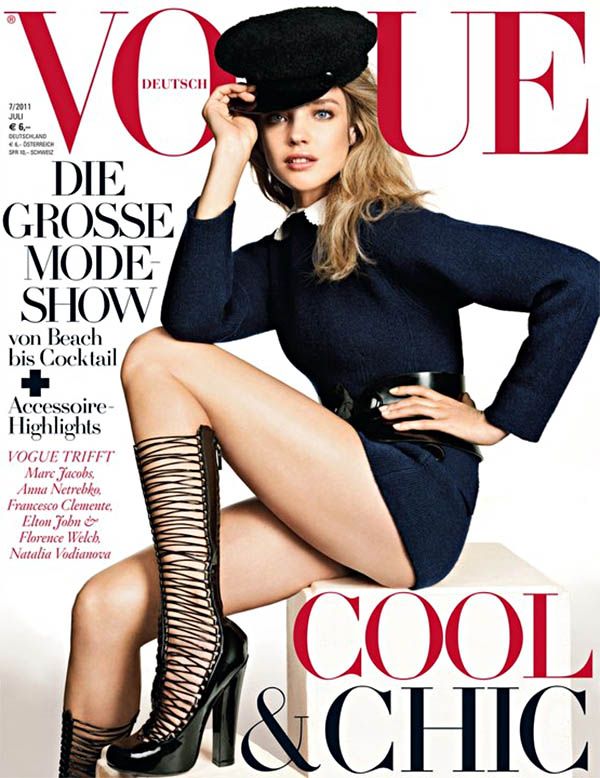 Woman in a navy dress and black hat on a magazine cover