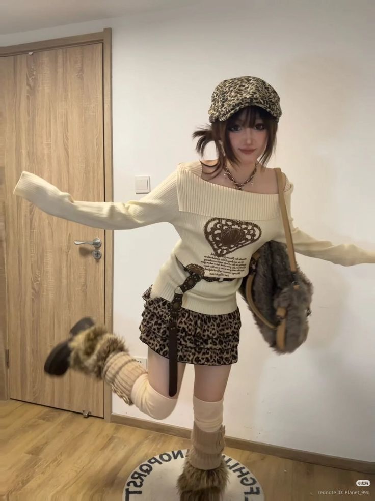 Woman in leopard print mini skirt and furry boots posing indoors