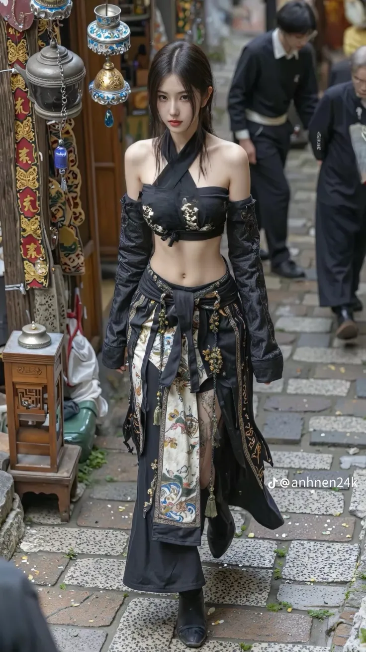 Woman in traditional black and gold clothing on a stone street