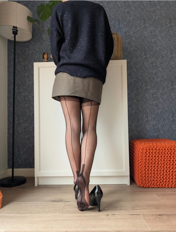 Person in black stockings and high heels from behind