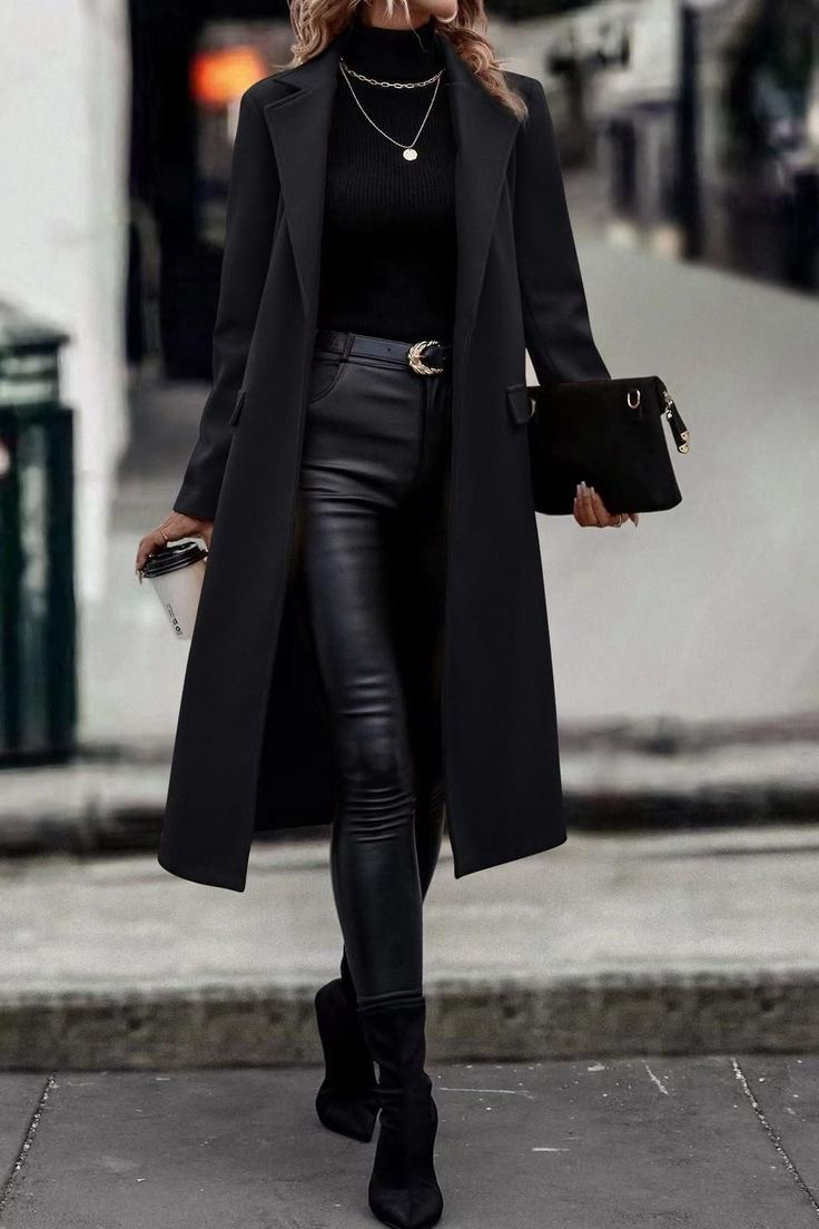 Woman in a black coat and leather pants walking outdoors