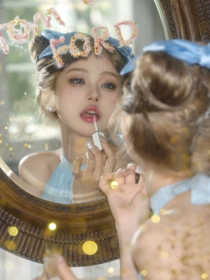 Woman applying lipstick in a mirror with blue bows in her hair