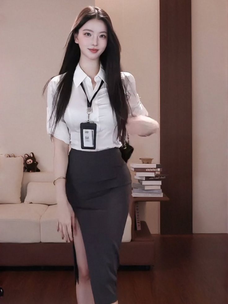 Woman in a white shirt and a high-slit pencil skirt indoors