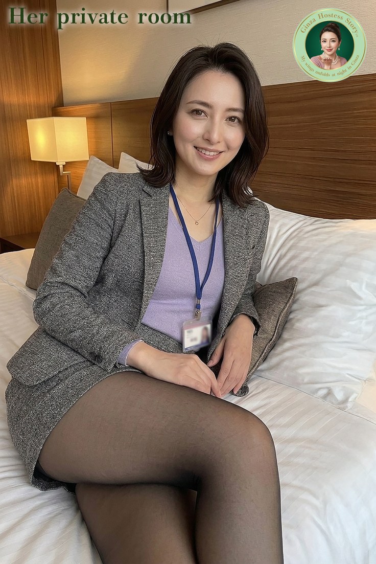 Woman in a suit jacket and mini skirt with black pantyhose sitting on a bed
