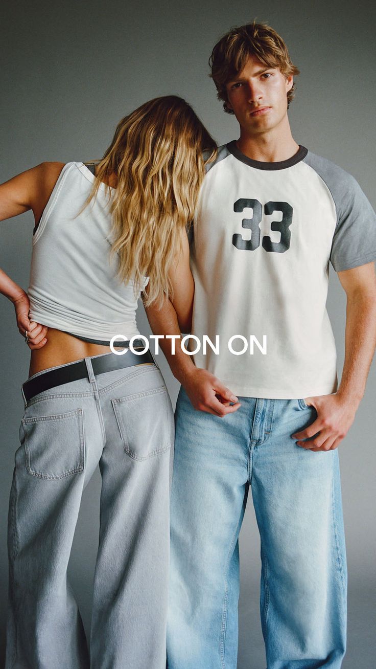 Two people in casual wear, woman leaning on man's shoulder