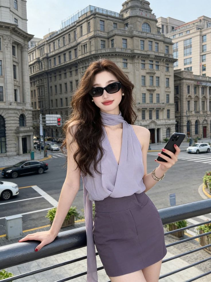 Woman with long hair and sunglasses in a city setting