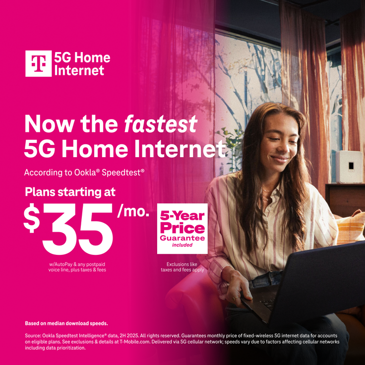 Woman with long hair sitting indoors and using a laptop