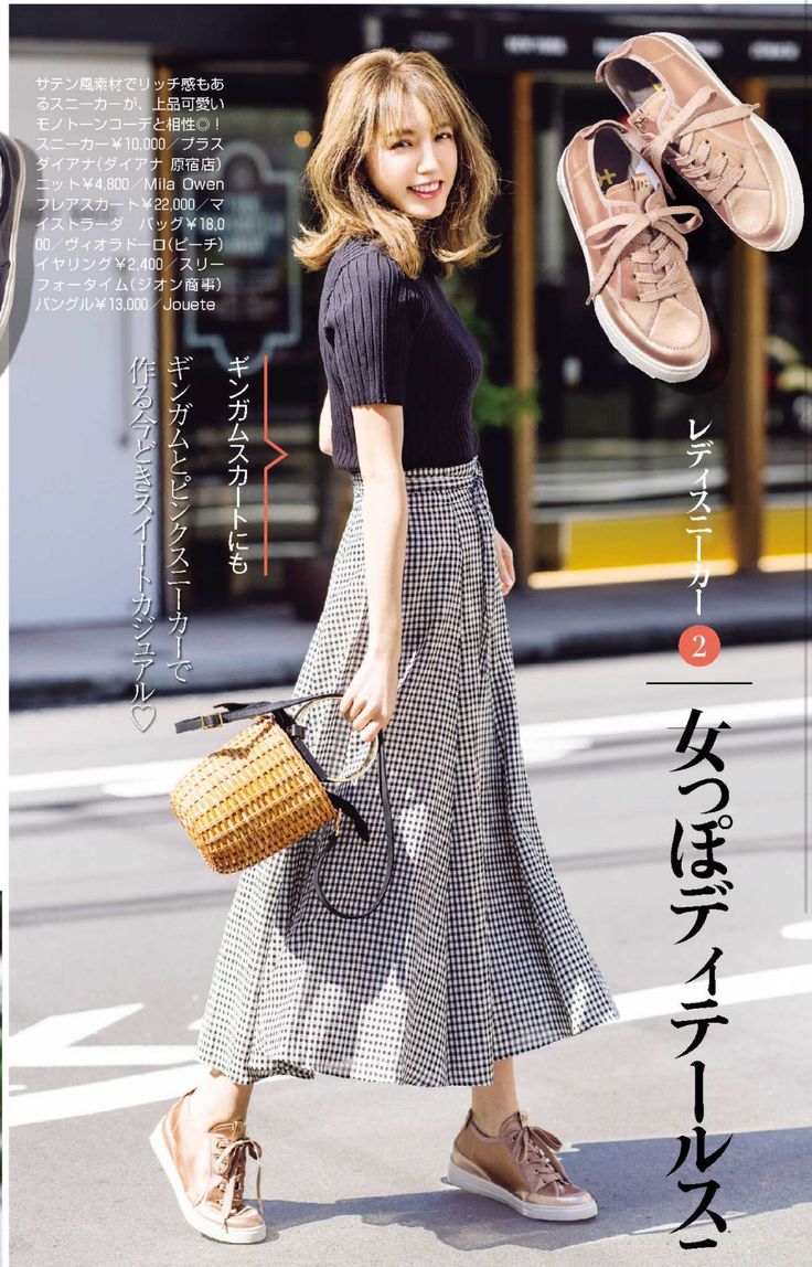 Woman in a black top and gingham skirt with a wicker bag and sneakers