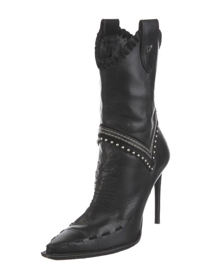Black leather cowboy boots with high heels and studded details