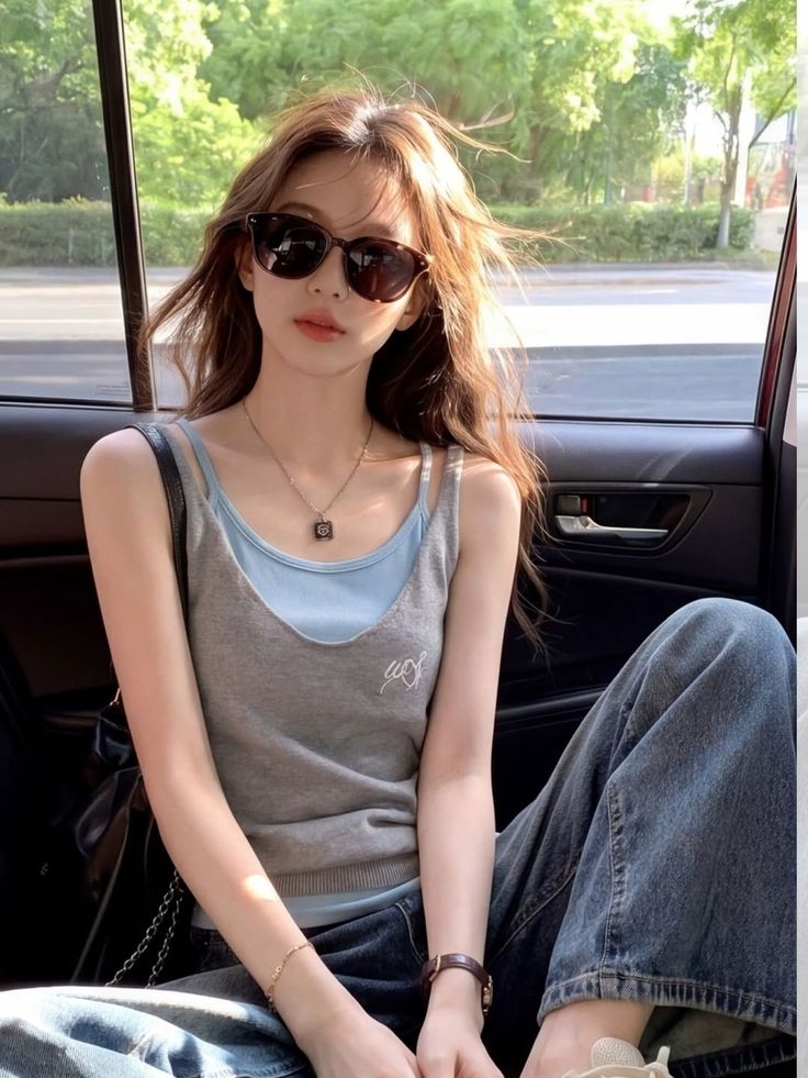 Woman with long hair and sunglasses in a car