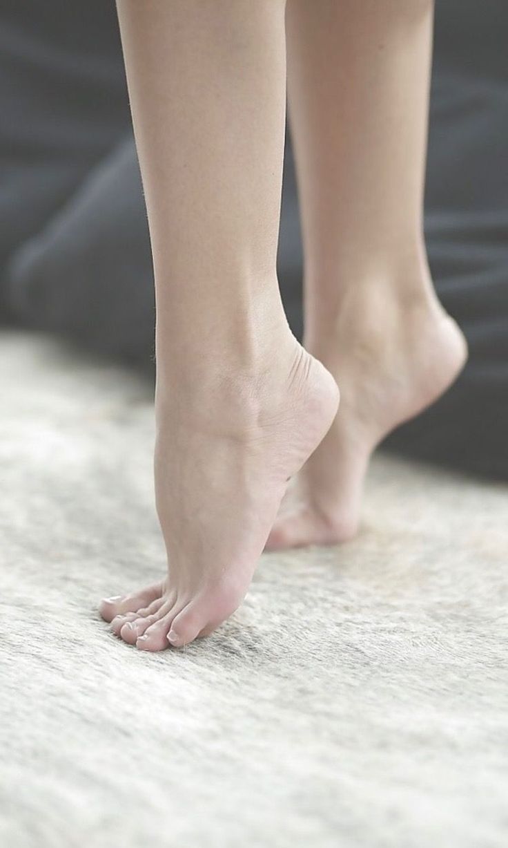 Bare feet on tiptoes on a furry rug