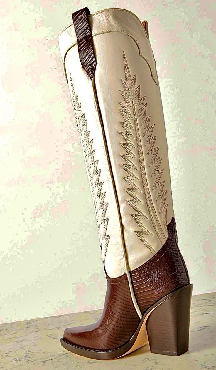 Brown and white cowboy boot with embroidered design and high heel