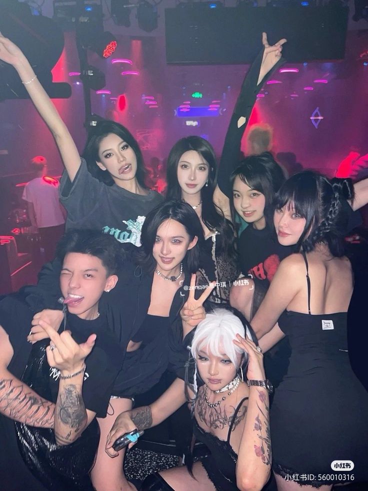 Group of people posing in a nightclub with neon lighting