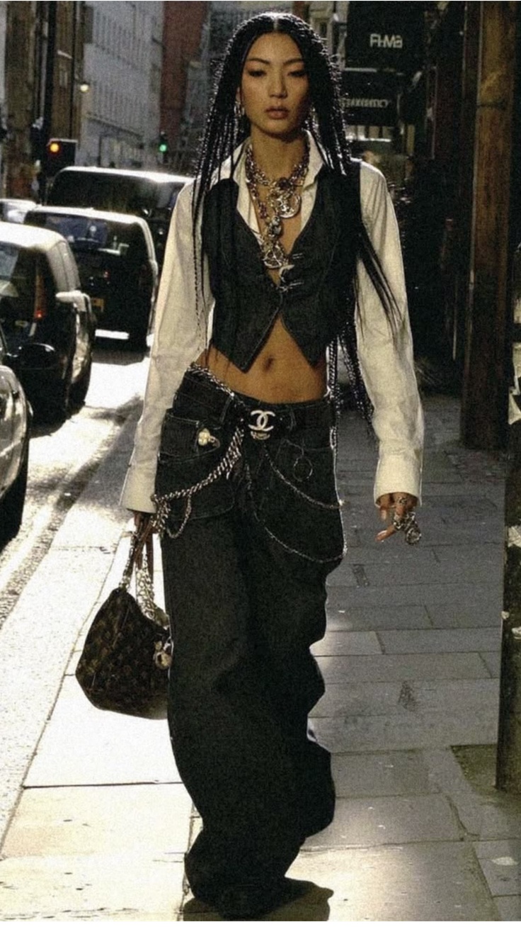 Woman with braided hair and baggy jeans walking on a street