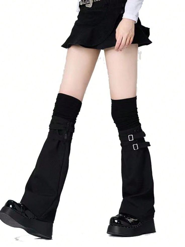 Person in a black skirt, leg warmers, and platform shoes on a white background