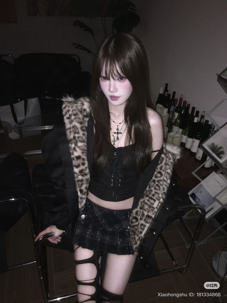 Woman in a leopard print jacket and mini skirt with ripped stockings