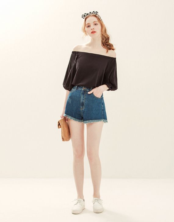 Woman in an off-shoulder top and denim shorts with a gingham headband