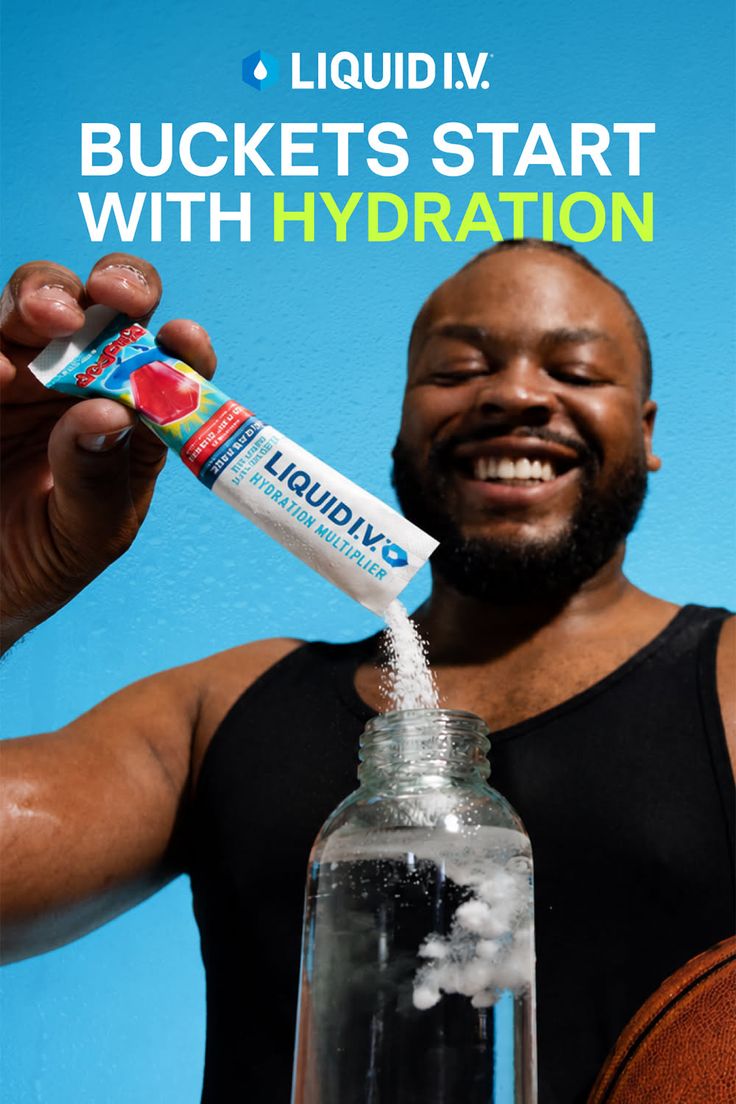 Man in a black tank top pouring hydration powder into a bottle