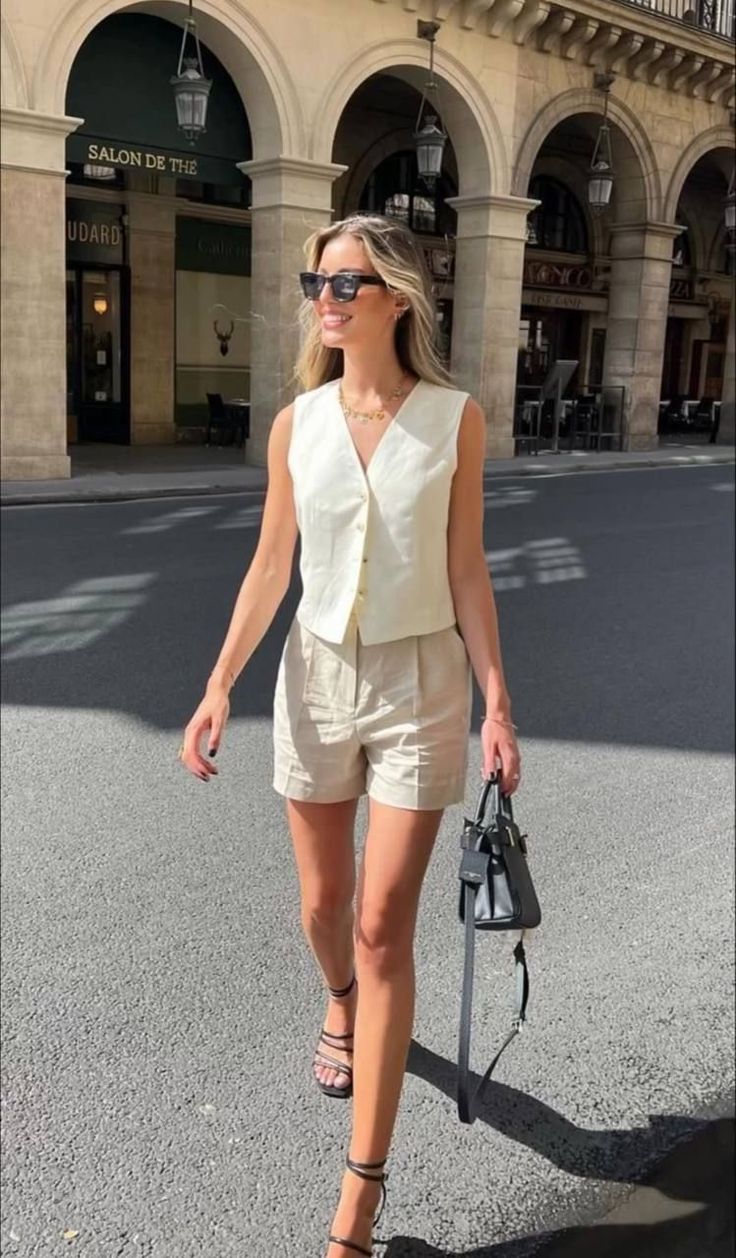 Woman in a sleeveless top and shorts walking on a street