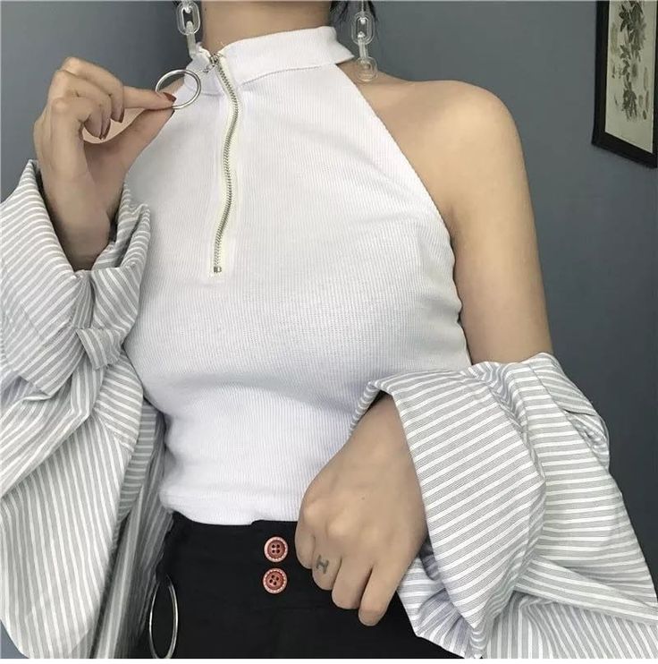 Woman in a white top with striped sleeves and an exposed shoulder