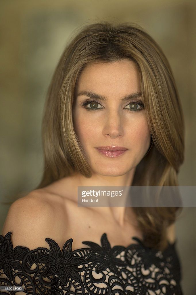 Woman with long hair wearing a black lace off-shoulder dress