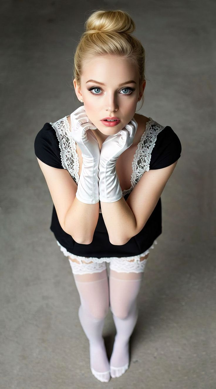 Blonde woman in a maid outfit with white gloves and thigh high stockings