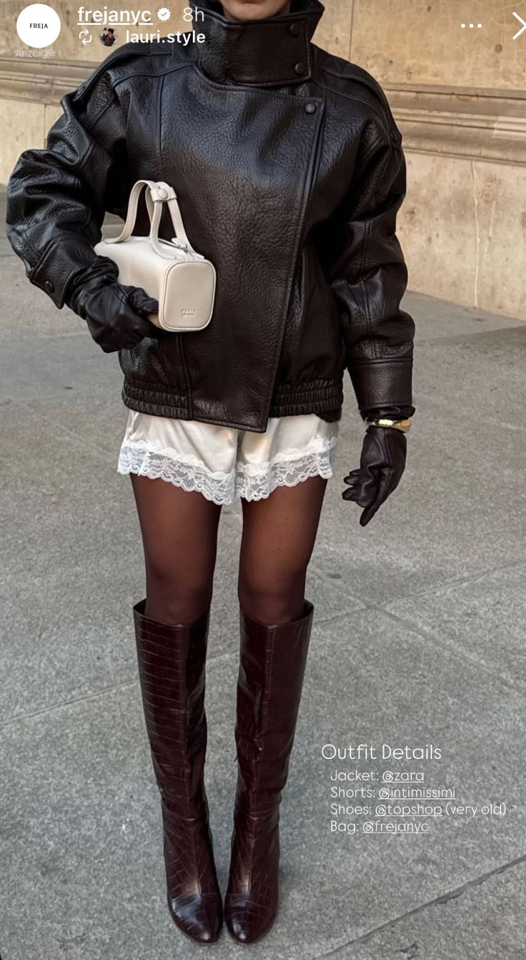 Person in a leather jacket, lace shorts, and knee-high boots on a street